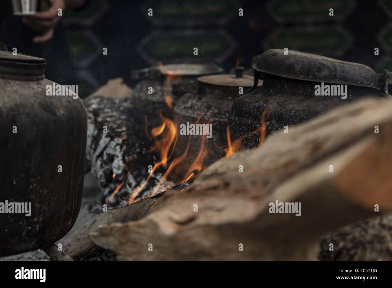 Alte schwarze Wasserkocher und Töpfe auf dem Feuer in einem parken Stockfoto