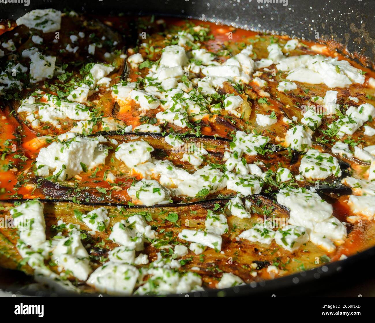 griechische braten-up mit Auberginen, Tomaten und Schafskäse in einer Pfanne Stockfoto