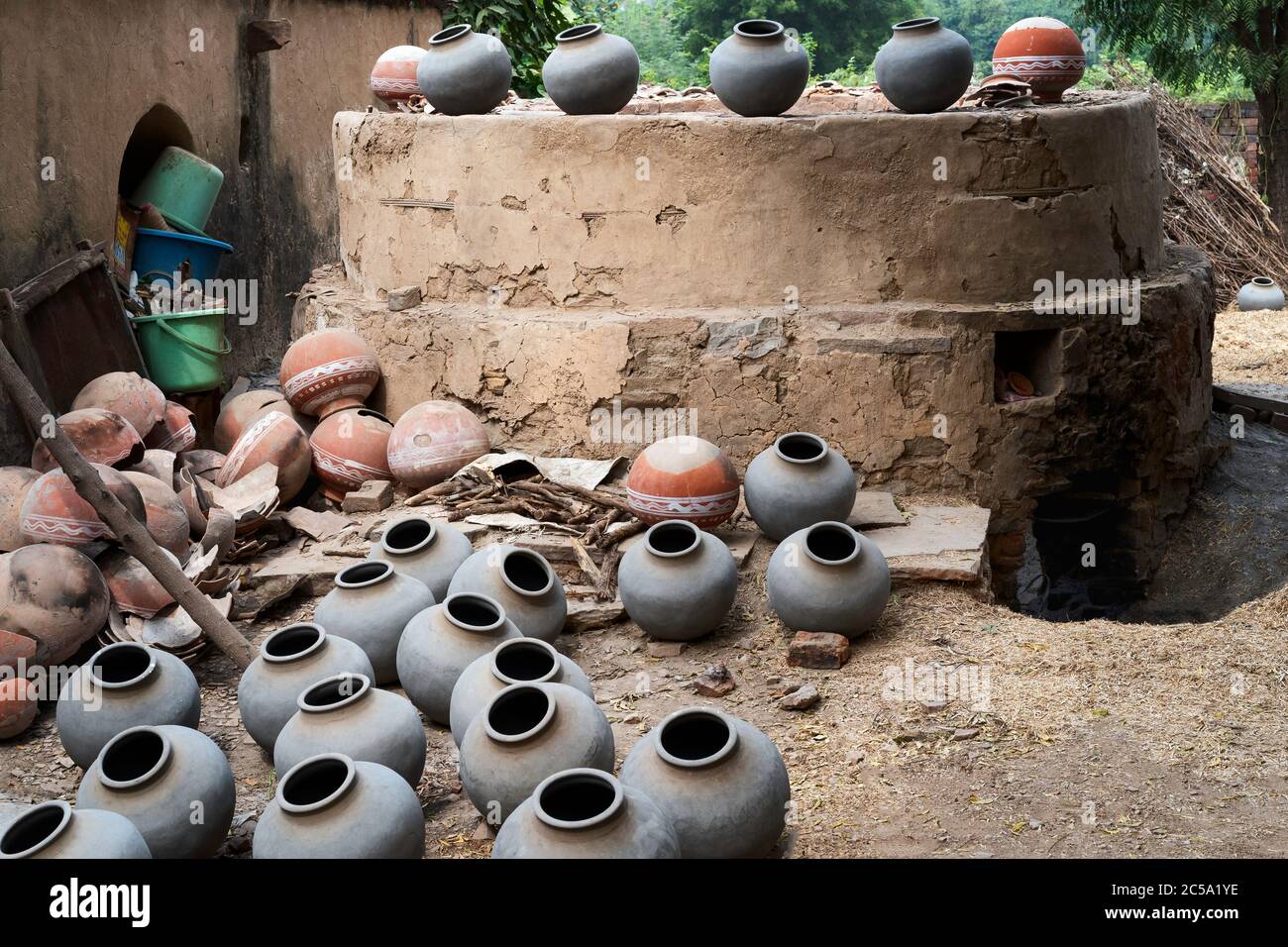 Traditionelle Töpfer Ziegelofen mit befeuerten Töpfen auf dem Boden in einem kleinen Dorf in Bundi, Rajasthan, Indien. Stockfoto