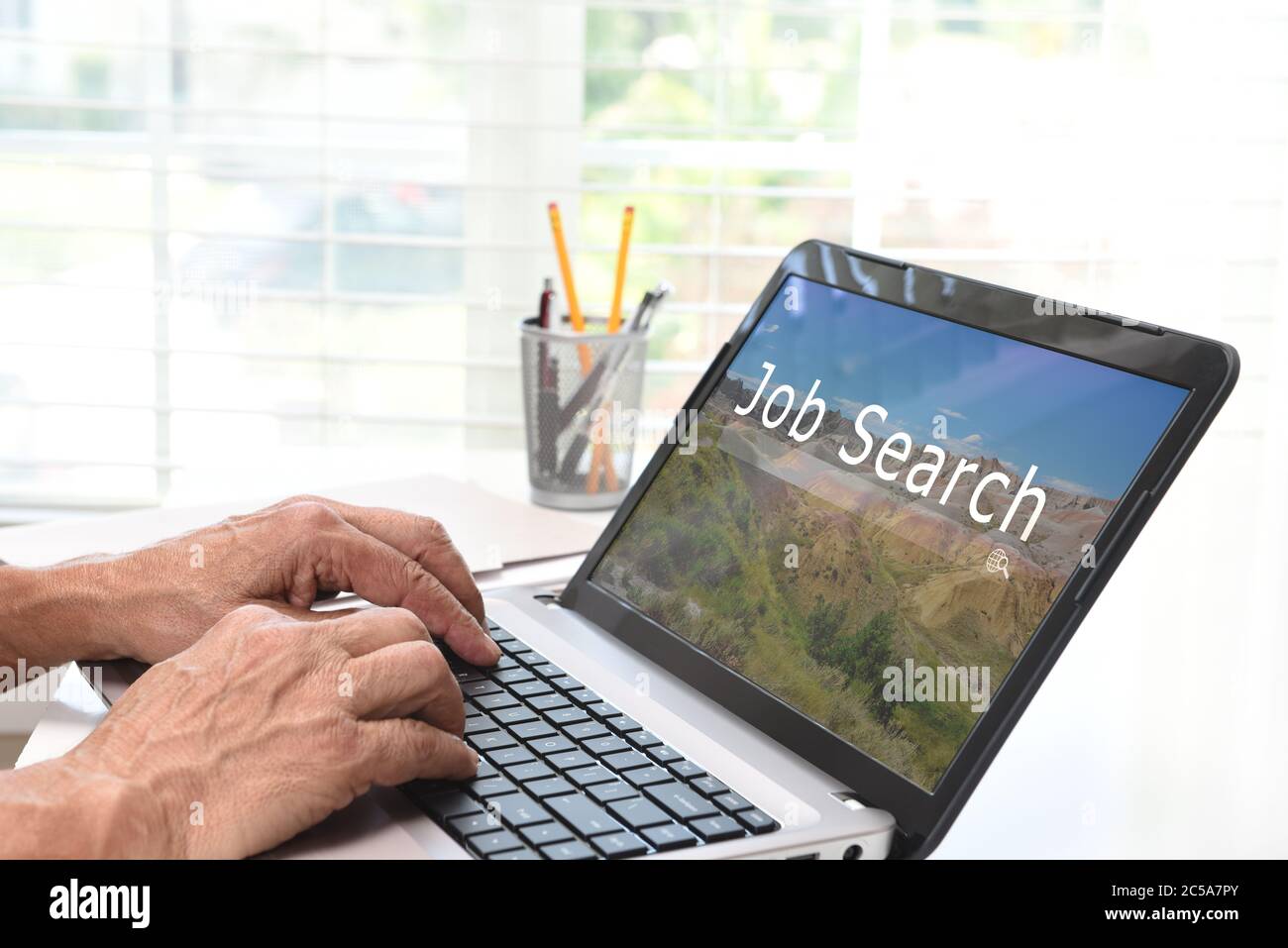 Konzept Der Online-Jobsuche. Nahaufnahme eines Mannes, der an seinem Laptop-Computer sitzt und eine Website mit Suchfeld besucht. Stockfoto