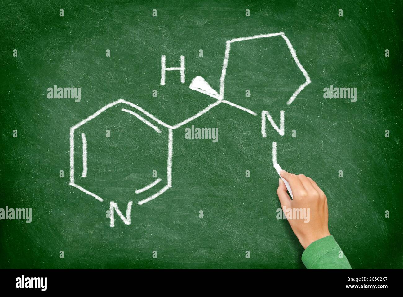 Nikotin. Chemische Struktur des Nikotins aus Zigaretten geschrieben auf Tafel von Lehrer in der Erziehung der Gesundheit. Nikotin-Molekül auf grüner Tafel. Stockfoto