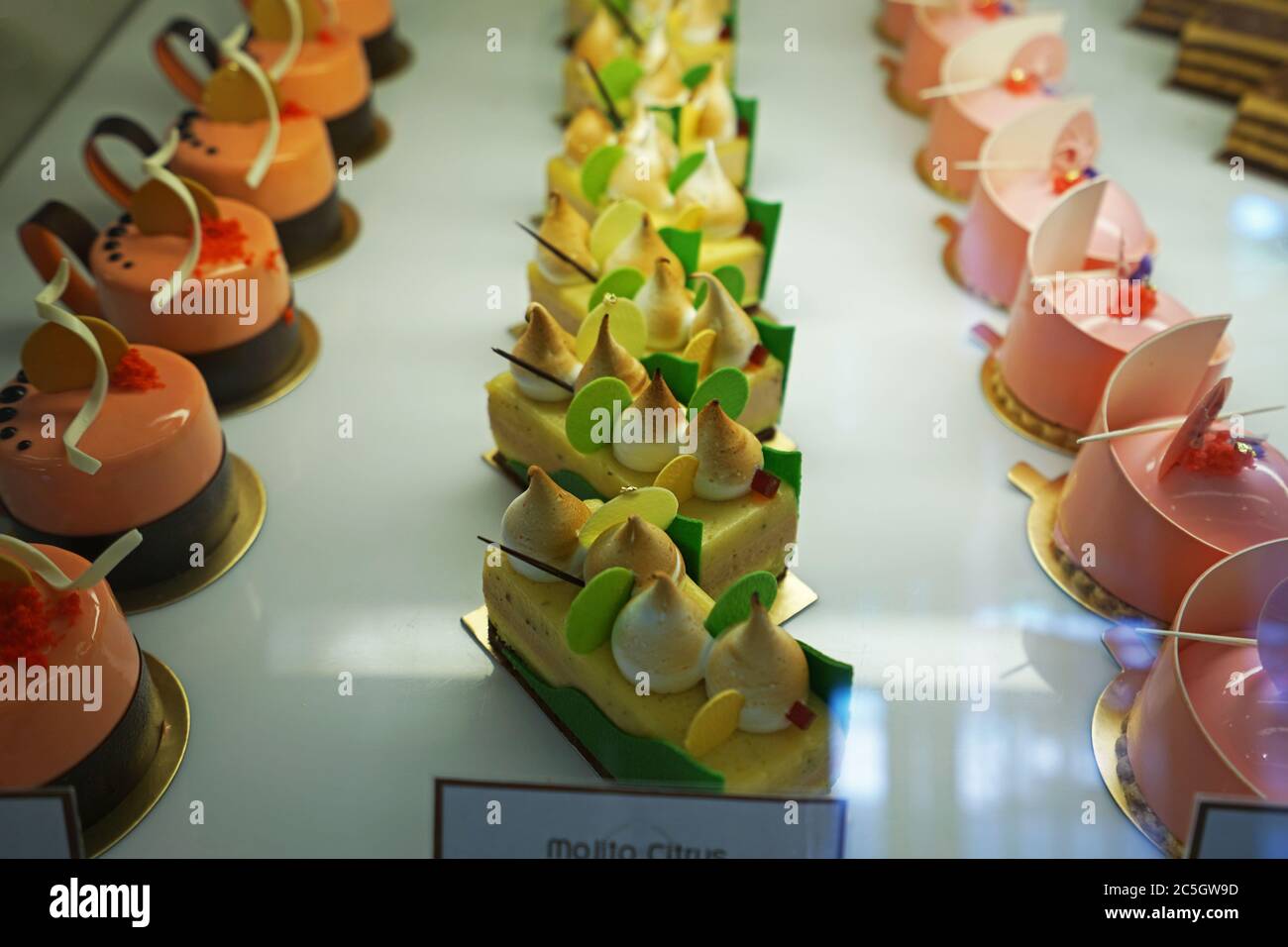 Verschiedene Geschmack bunte eclair und Französisch Gebäck Bäckerei in Glas Vitrine Box angezeigt Stockfoto