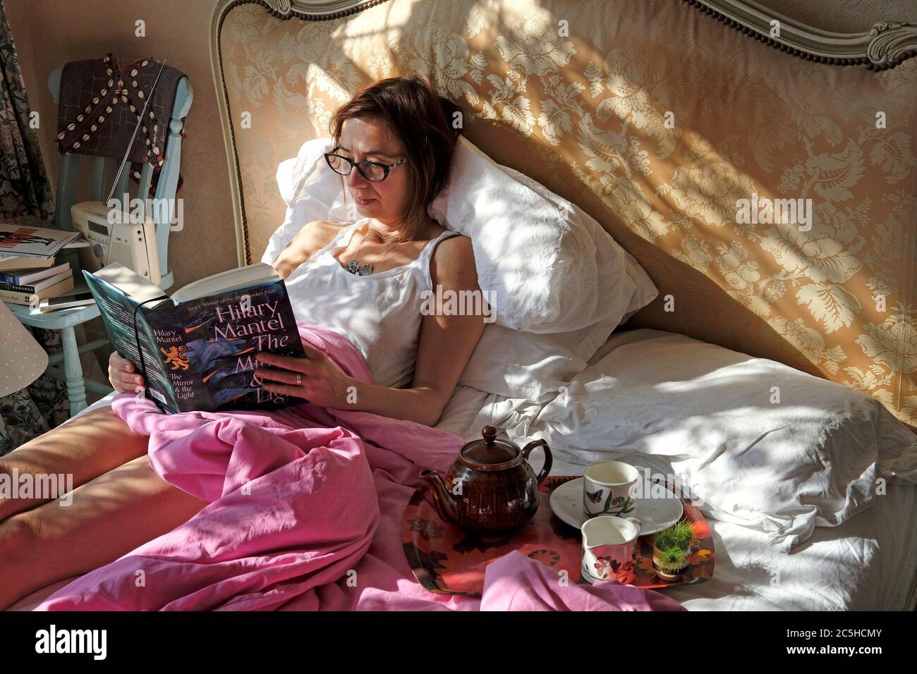 Eine Frau beim Frühstück im Bett. Stockfoto