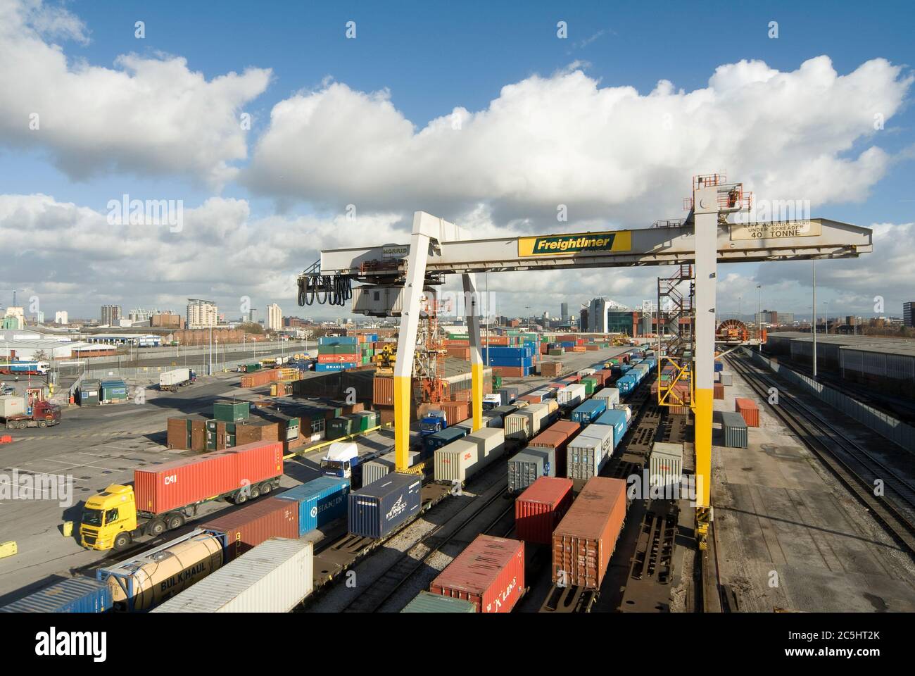 Kran und Transportbehälter auf Schienen im Manchester Euroterminal, Trafford Park, Manchester, England. Stockfoto