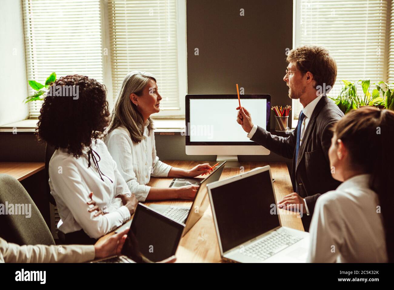 Geschäftsmann hat eine Idee. Projektpräsentation bei Treffen mit einem vielfältigen Team. Getöntes Bild Stockfoto