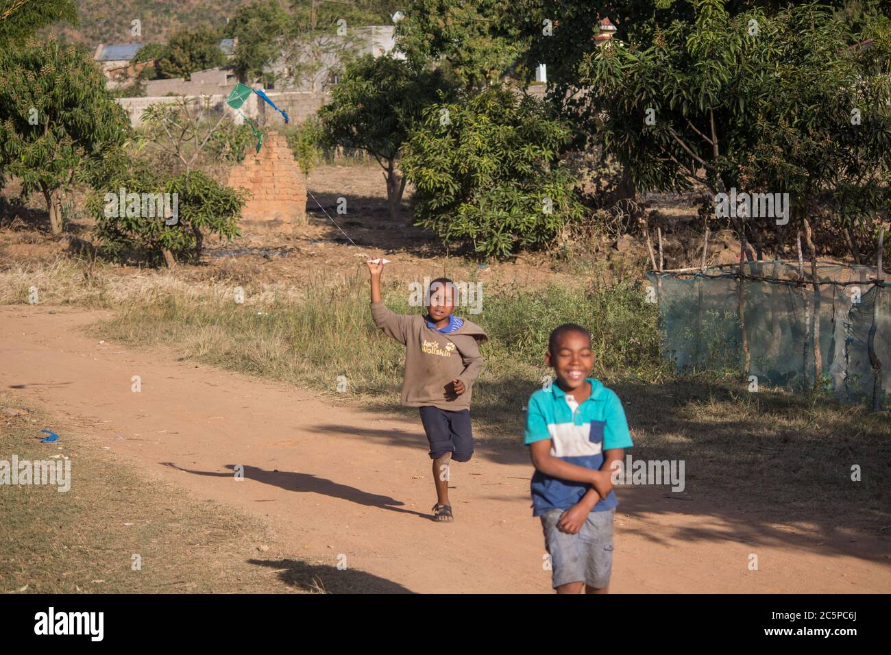 Boy fliegende Drachen Spielzeug aus recycelten Plastiktüten und Sticks in Afrika Stockfoto