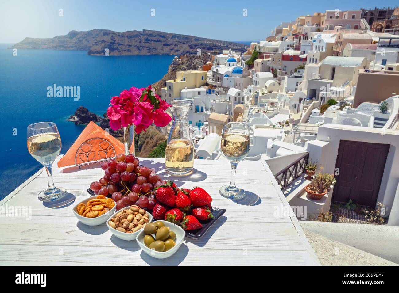 Wein, Snacks und Obst auf dem Tisch mit Blick auf das griechische Meer Stockfoto