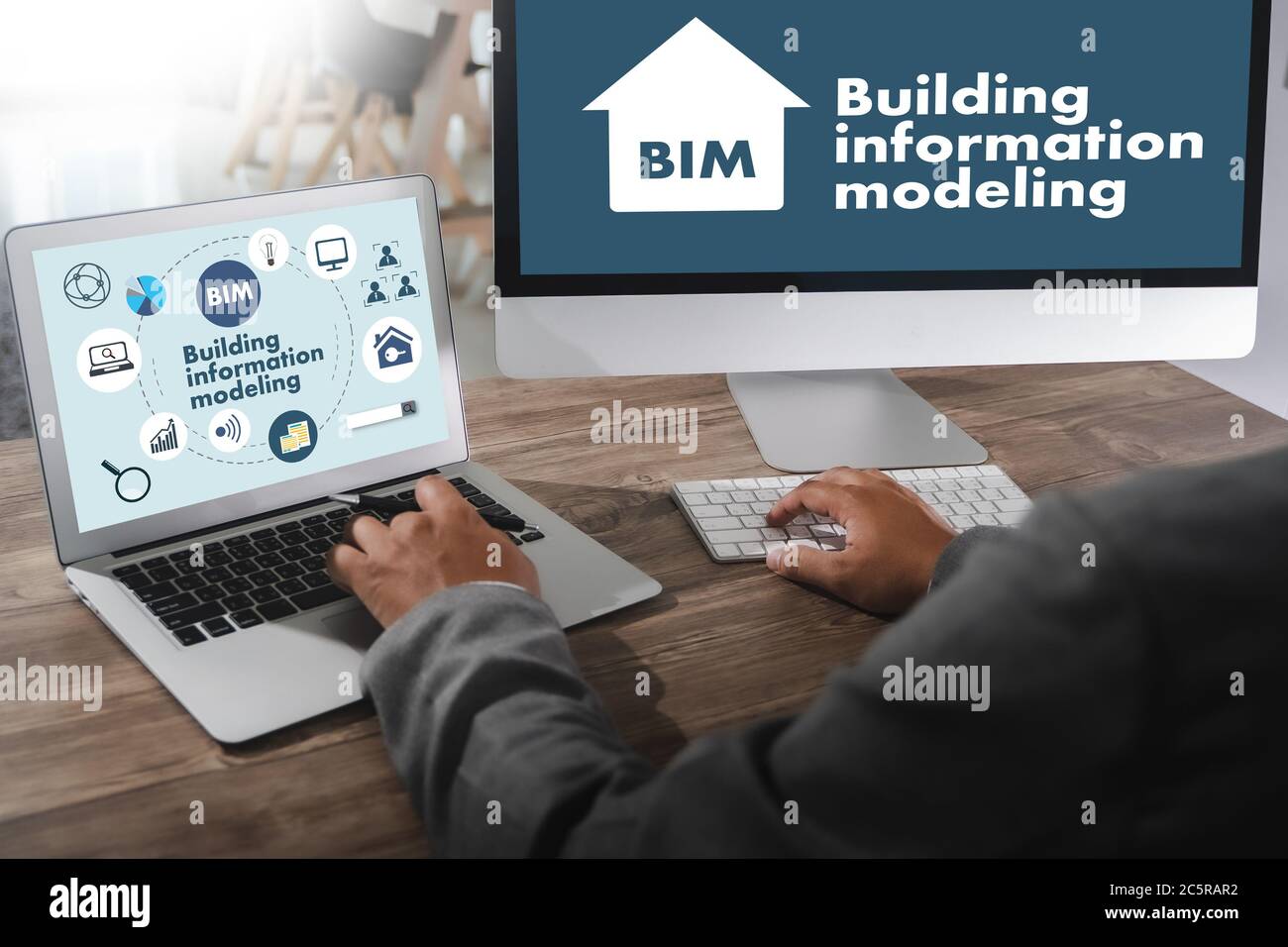 BIM Business Team hands at work with Financial Reports BIM - Building information modelling and a Laptop Stockfoto