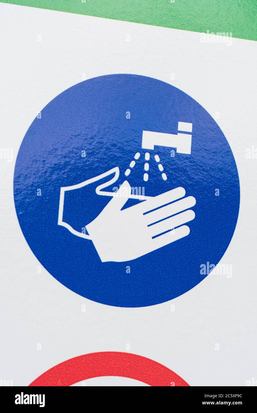 CV19, Covid-19 Schule Sicherheitsmassnahmen Warnschild & Warnpiktogramme am Tor der St. winnow Primary School, Lostwithiel. Piktogramm Hände waschen Stockfoto