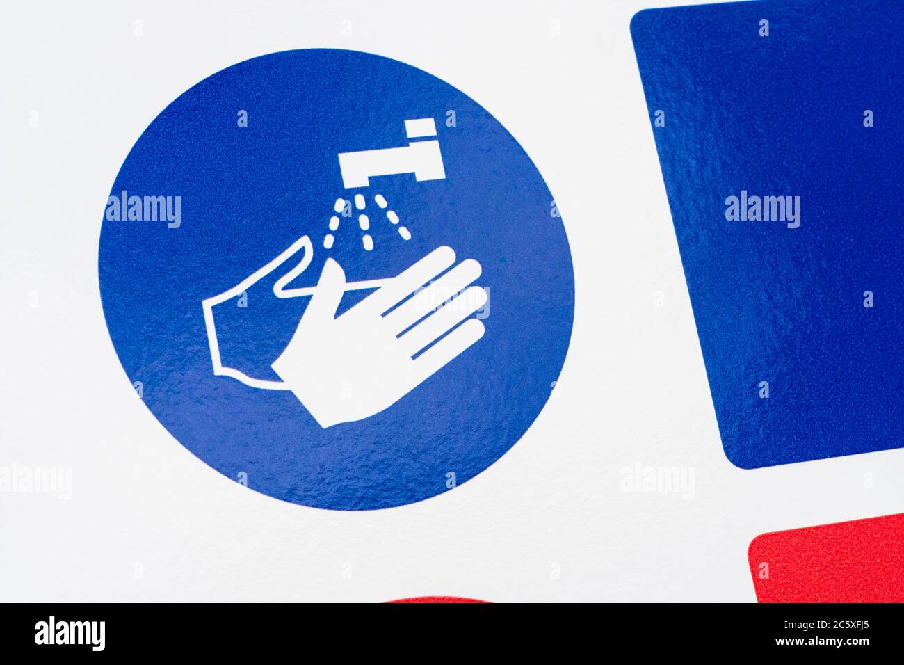 CV19, Covid-19 Schulgelände Sicherheitsmaßnahmen Warnschild & Warnpiktogramm am Tor der St. winnow Primary School, Lostwithiel. Piktogramm Hände waschen Stockfoto