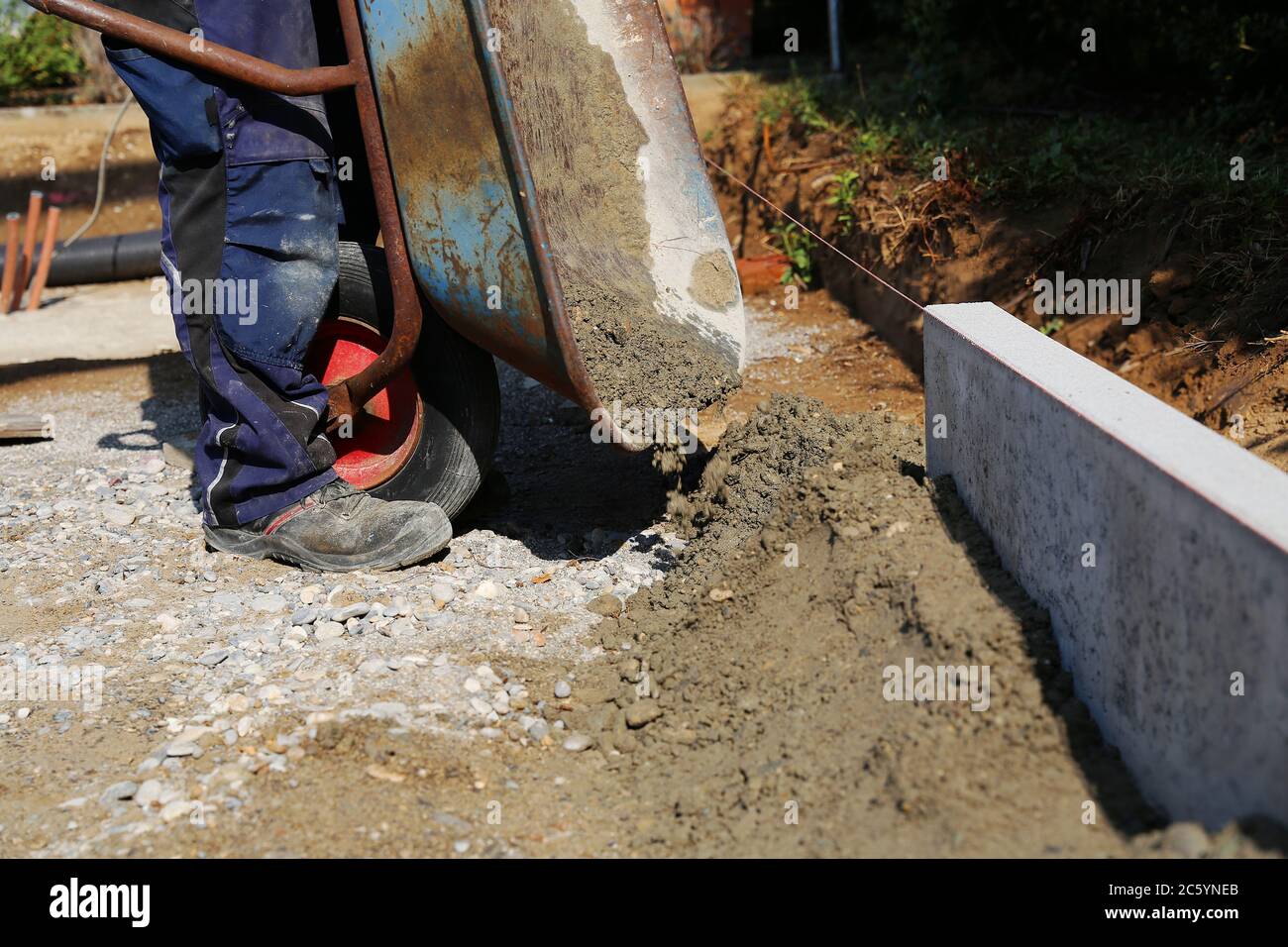 Bauarbeiter sitzen an der Bordsteinkante Stockfoto