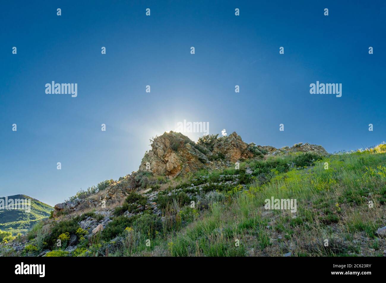 Sonne hinter Berggipfel, Park City Utah, USA Stockfoto