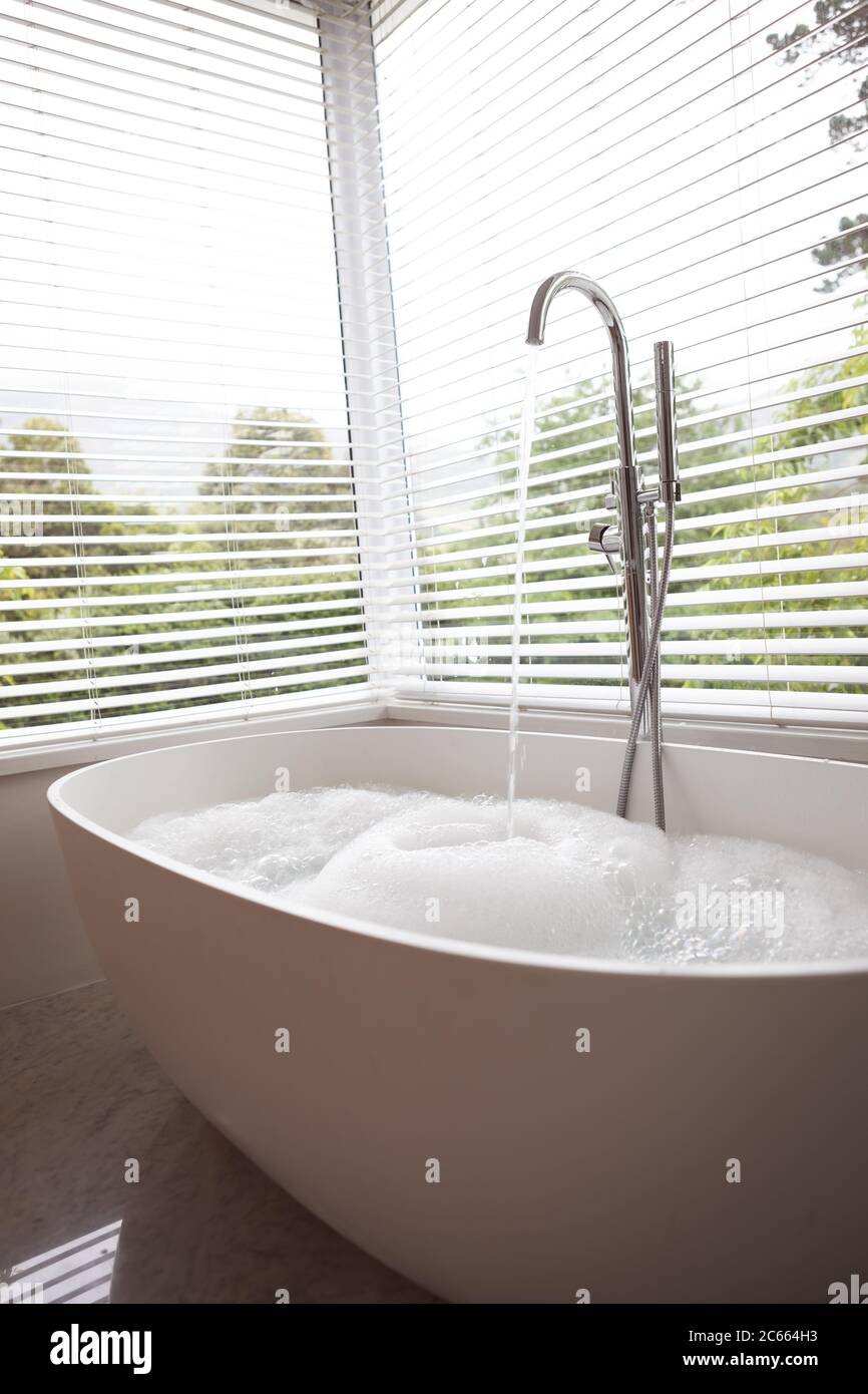 Fließendes Wasser in moderner Badewanne Stockfoto