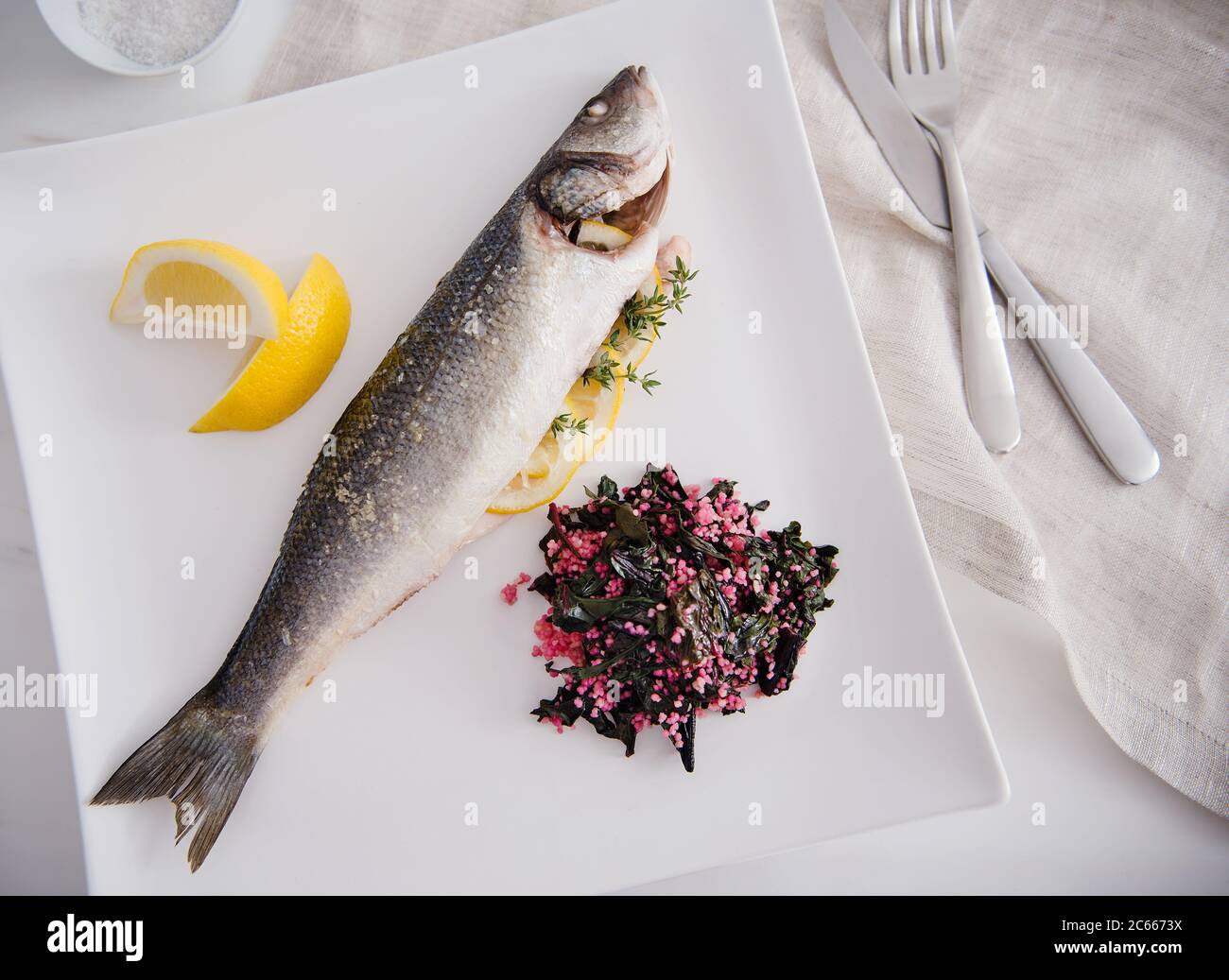 Fischabendessen mit Zitrone, gekochtem Mangold und Quinoa Stockfoto