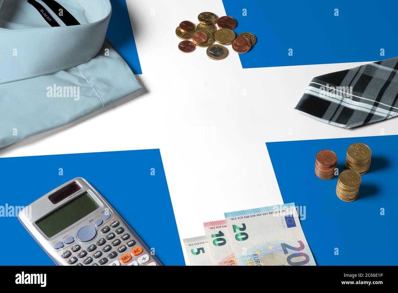 Schottland Flagge auf Minimal Money Concept Table. Münzen und Finanzobjekte auf Flaggenoberfläche. Thema der Volkswirtschaft. Stockfoto
