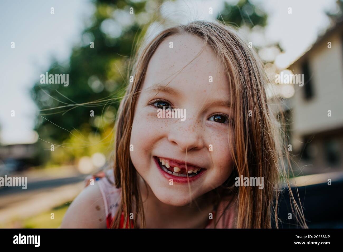 Glückliches junges Mädchen lächelnd und zeigt fehlende Zahn Stockfoto