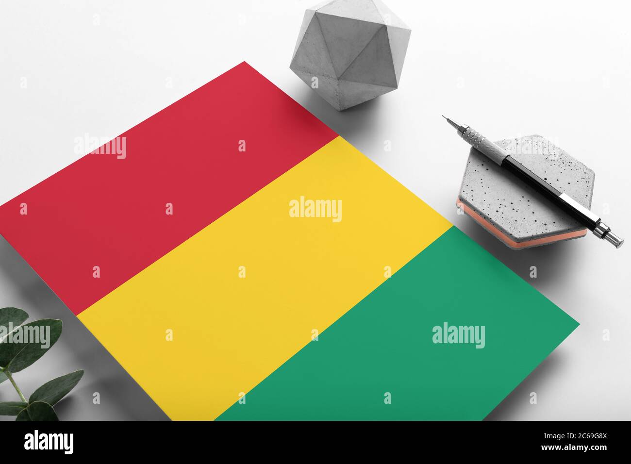 Guinea Bissau Flagge auf minimalistischem Papier Hintergrund. Nationale Einladung Brief mit stilvollen Stift auf Stein. Kommunikationskonzept. Stockfoto