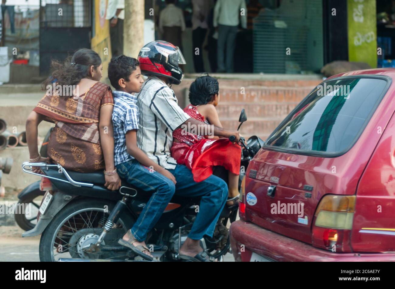 Eine ganze Familie auf einem Motorrad. Mann fährt. Mutter und Sohn reiten auf dem Sozius, während die Tochter auf dem Tank sitzt. Stockfoto