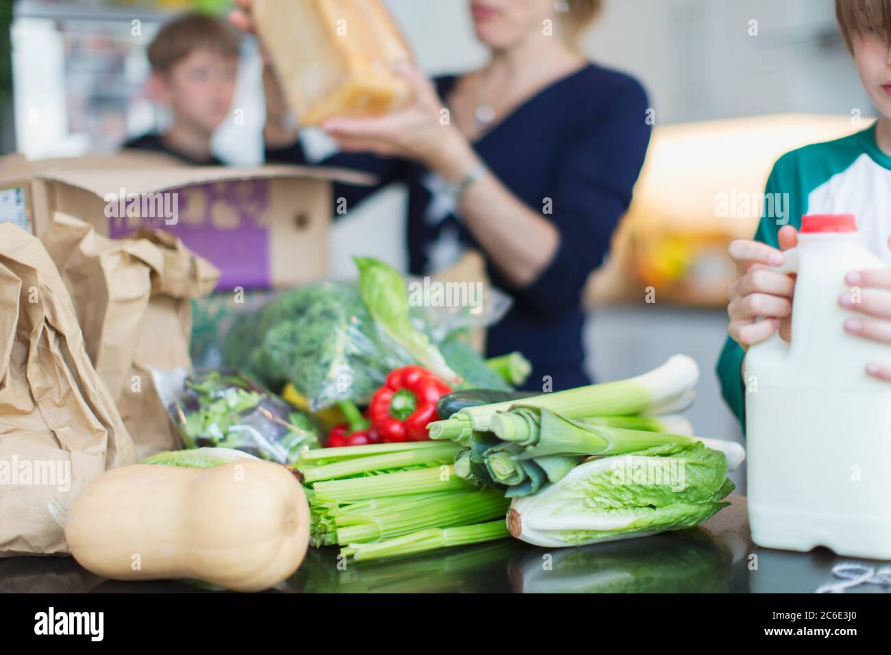 Familie Entladen frische Produkte in der Küche Stockfoto