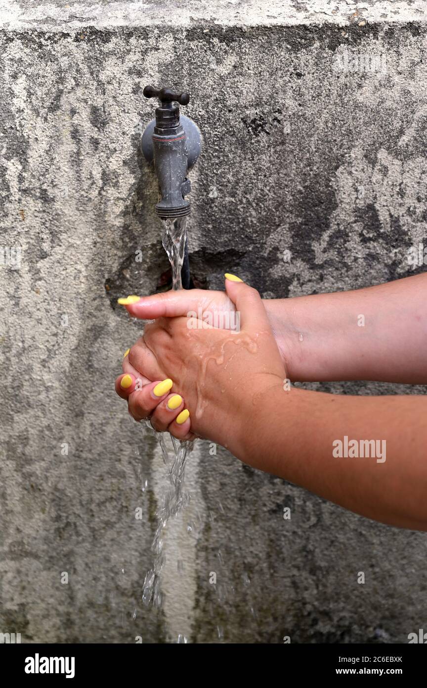 Öffentlicher Brunnen im Dorf. Covid-19 ist gefährlich und wahsing Hände ist ein Gesundheitsschutz Stockfoto