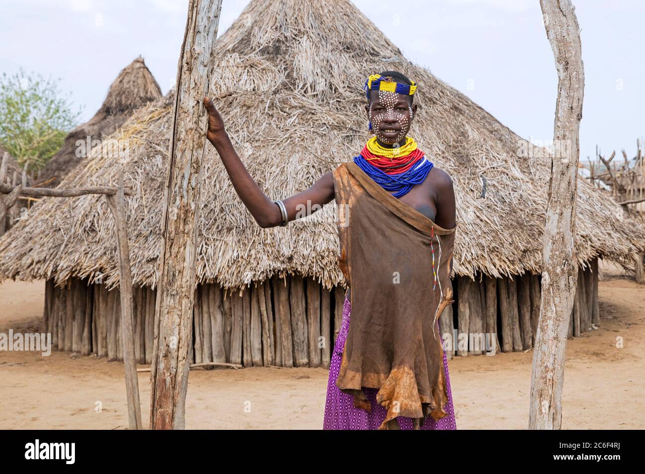 Schwarze Frau mit gemaltem Gesicht des Karo / Kara Stammes vor Hütte im Dorf, Unteres Omo-Tal, Debub Omo Zone, Süd-Äthiopien, Afrika Stockfoto