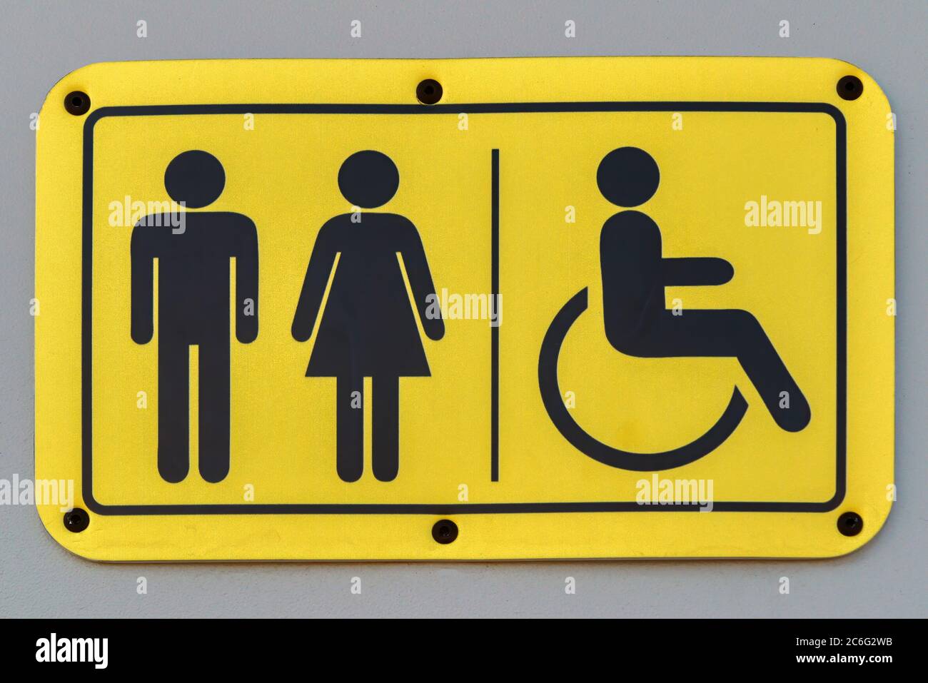 Ein Teller mit symbolischen Bildern von einem Mann, einer Frau und einer Person im Rollstuhl. Stockfoto