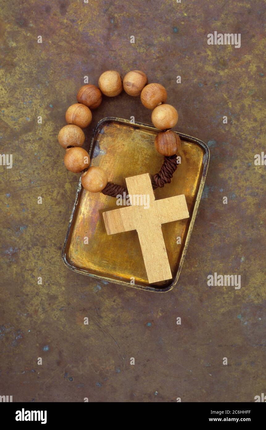 Kleiner Messingdeckel mit Holzkreuz mit Rosenkranz Stockfoto