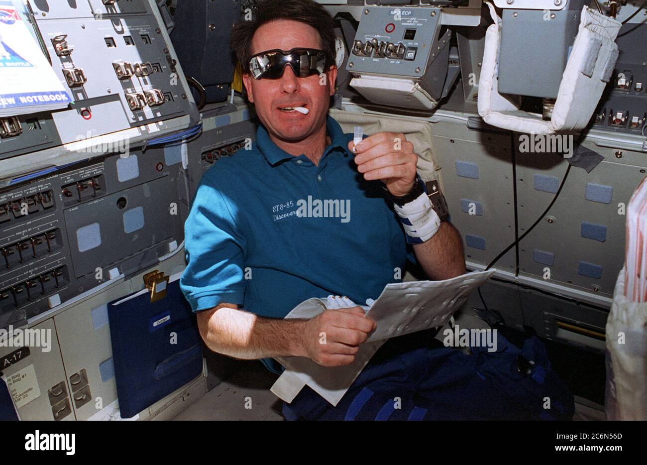 (7. - 19. August 1997) --- auf dem Flugdeck des Space Shuttle Discovery führt Astronaut Stephen K. Robinson eine Phase der detaillierten Zusatzziele (DSO) der Mission durch. Er nimmt mit einem Wattestäbchen eine Speichelprobe auf. Das Handgelenkband am linken Arm ist mit demselben DSO assoziiert. Der laufende Test, der sich mit dem zirkadianen Rhythmus und anderen biologischen Systemen beschäftigt, ist in Vorbereitung für die Internationale Raumstation ISS. Stockfoto