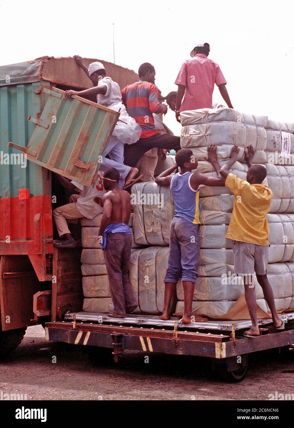 1994 - das lokale Personal brechen Paletten und Ladungen mit Lieferungen, die in Ruanda zu den Flüchtlingslagern gefahren werden. Stockfoto