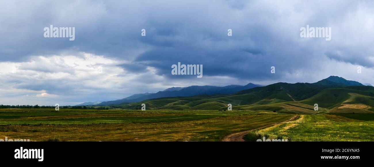 Panorama eines Bergtals im Sommer, wolkigen Himmel. Märchenhafter Sonnenuntergang über den Berggipfeln, herrliche Natur, Sommer in den Bergen. Reisen. Be Stockfoto