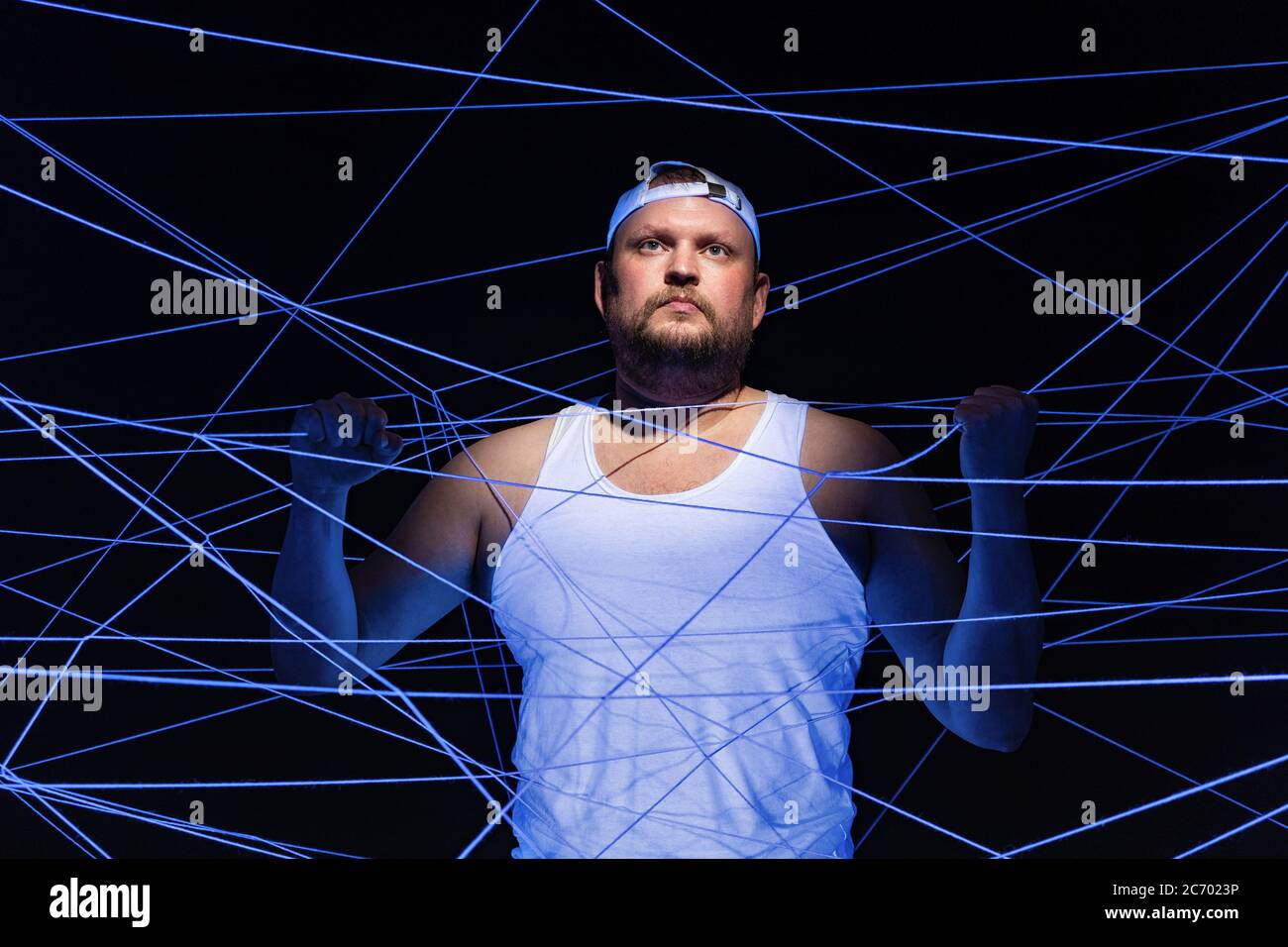 Bild von fetten Menschen verwickelt in weißen Fäden in ultravioletten Stockfoto