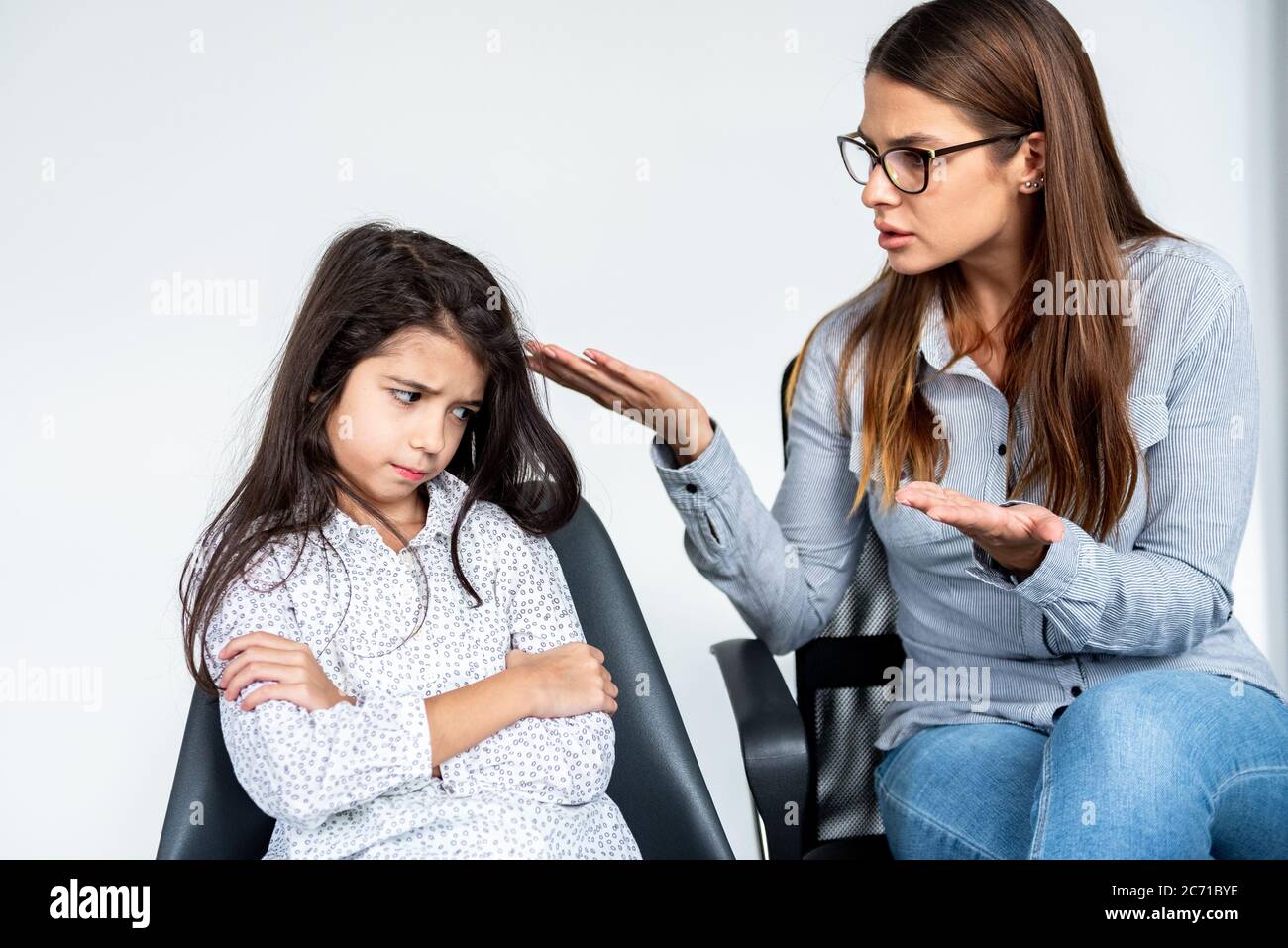 Junge strenge Mutter oder Schwester schimpfen hartnäckige Kind Mädchen. Stockfoto