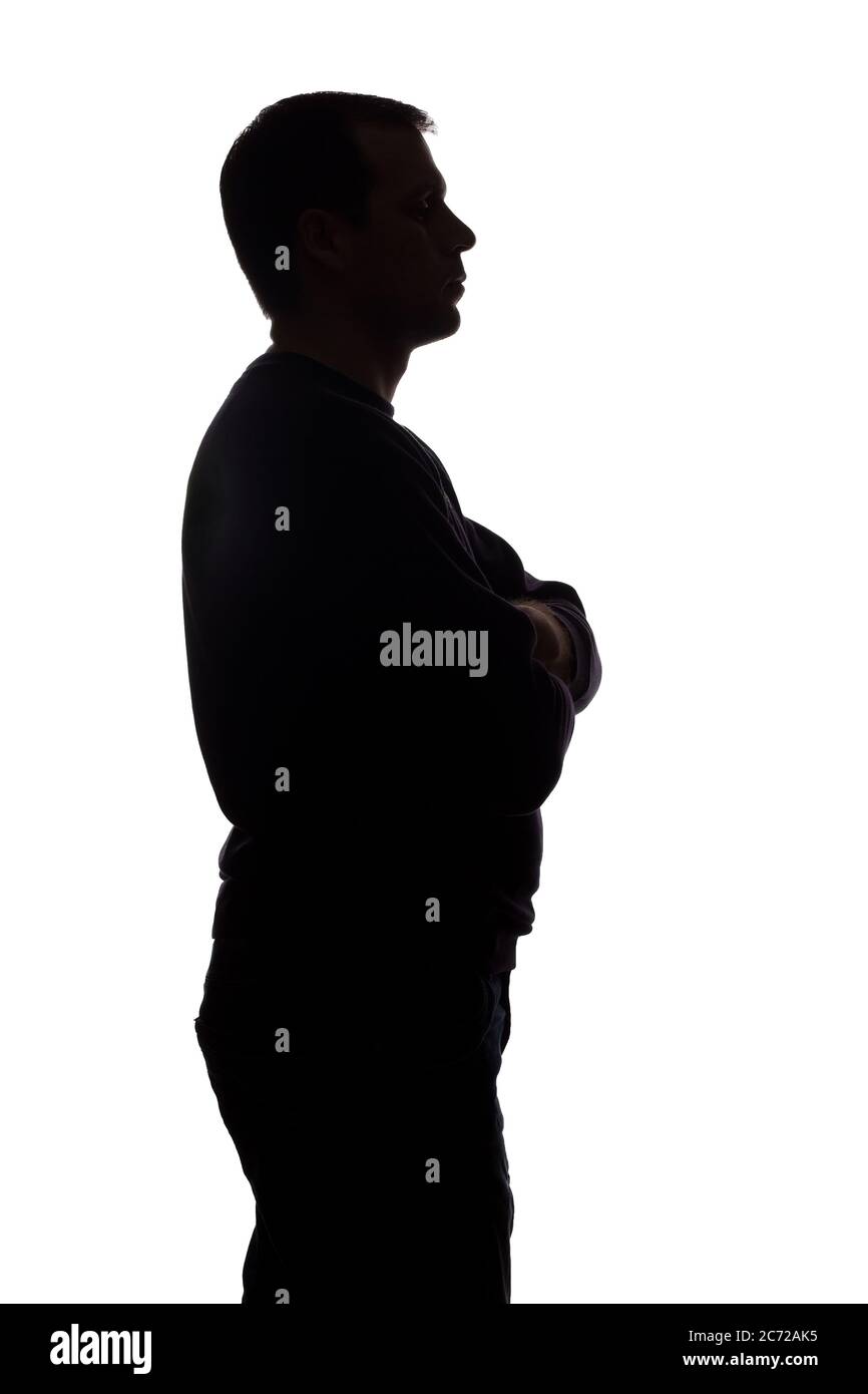 Porträt eines jungen Mannes, unrasiert, Seitenansicht - dunkel isoliert Silhouette Stockfoto