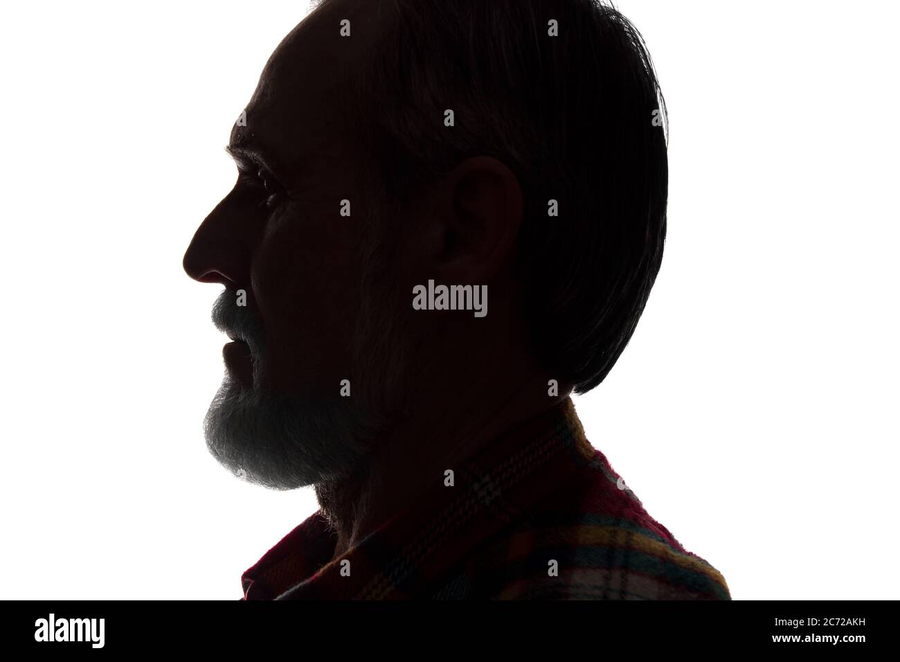 Porträt eines alten Mannes, unrasiert, mit Bart, Seitenansicht - dunkel isolierte Silhouette Stockfoto