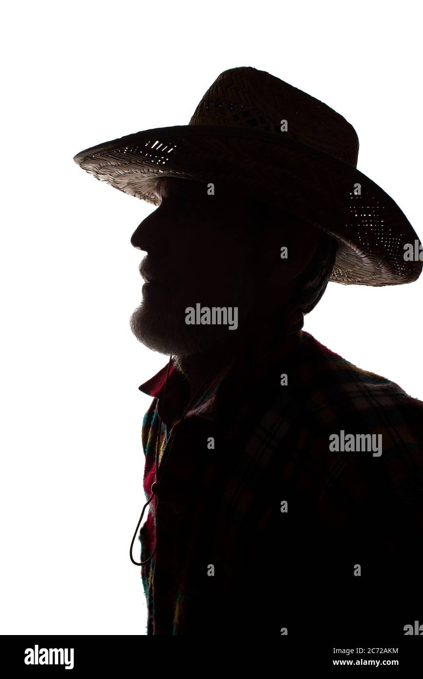 Porträt eines alten Mannes, in einem Cowboy-Hut, mit Bart, Seitenansicht - dunkel isoliert Silhouette Stockfoto
