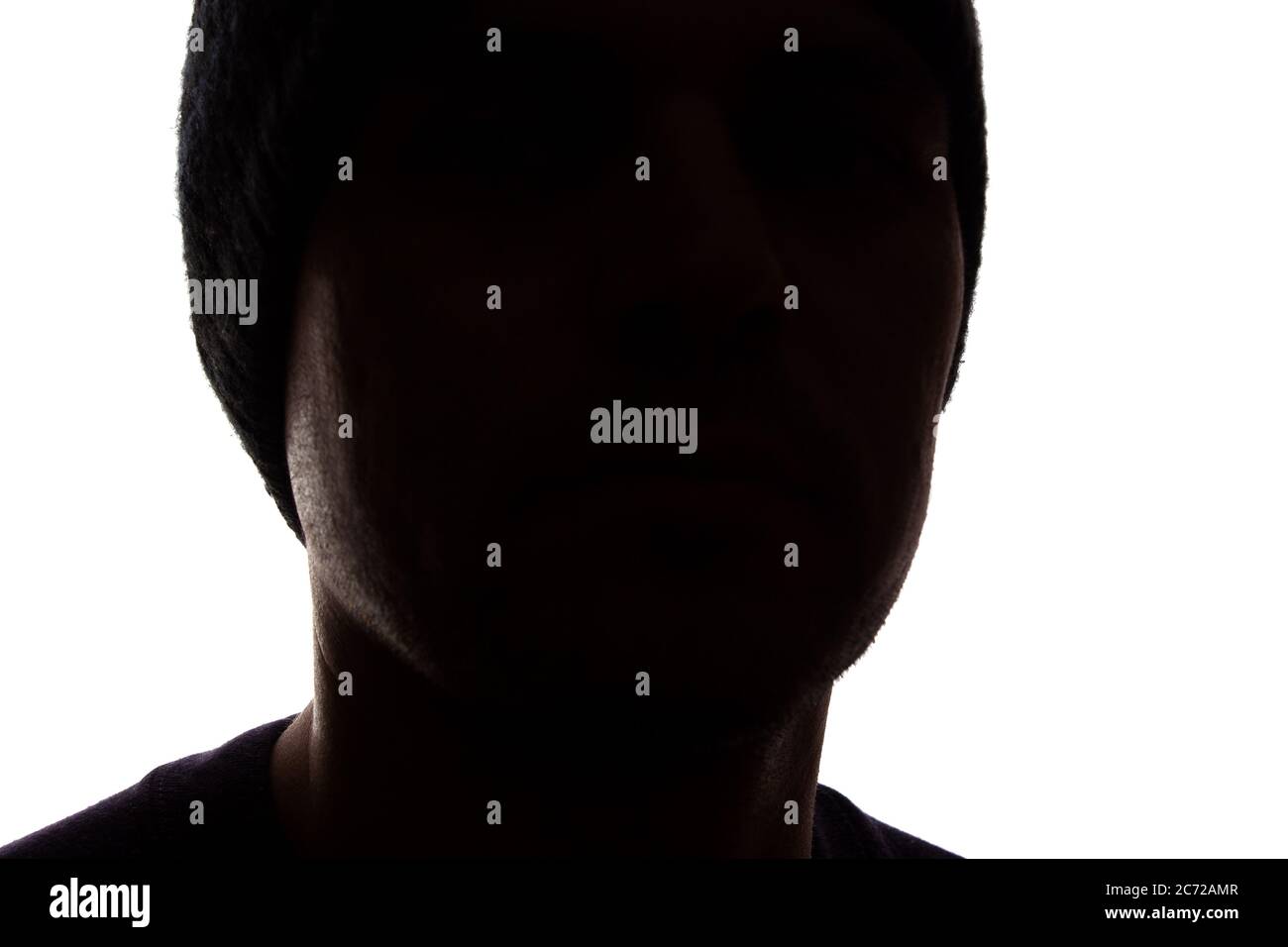 Porträt eines jungen Mannes, unrasiert, Seitenansicht in Mütze - dunkel isolierte Silhouette Stockfoto