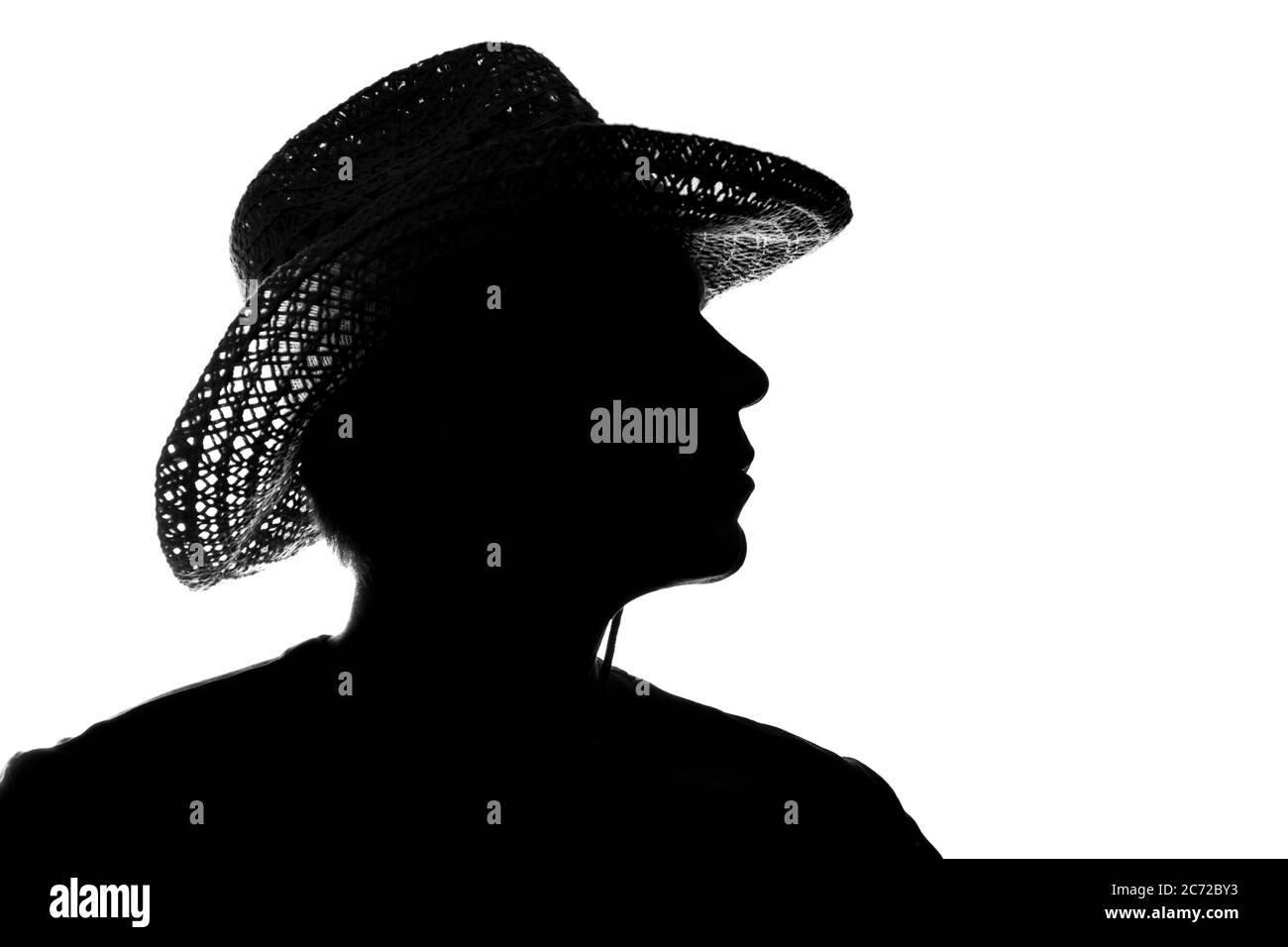 Junger Mann in einem Strohhut Silhouette - Seitenansicht Stockfoto