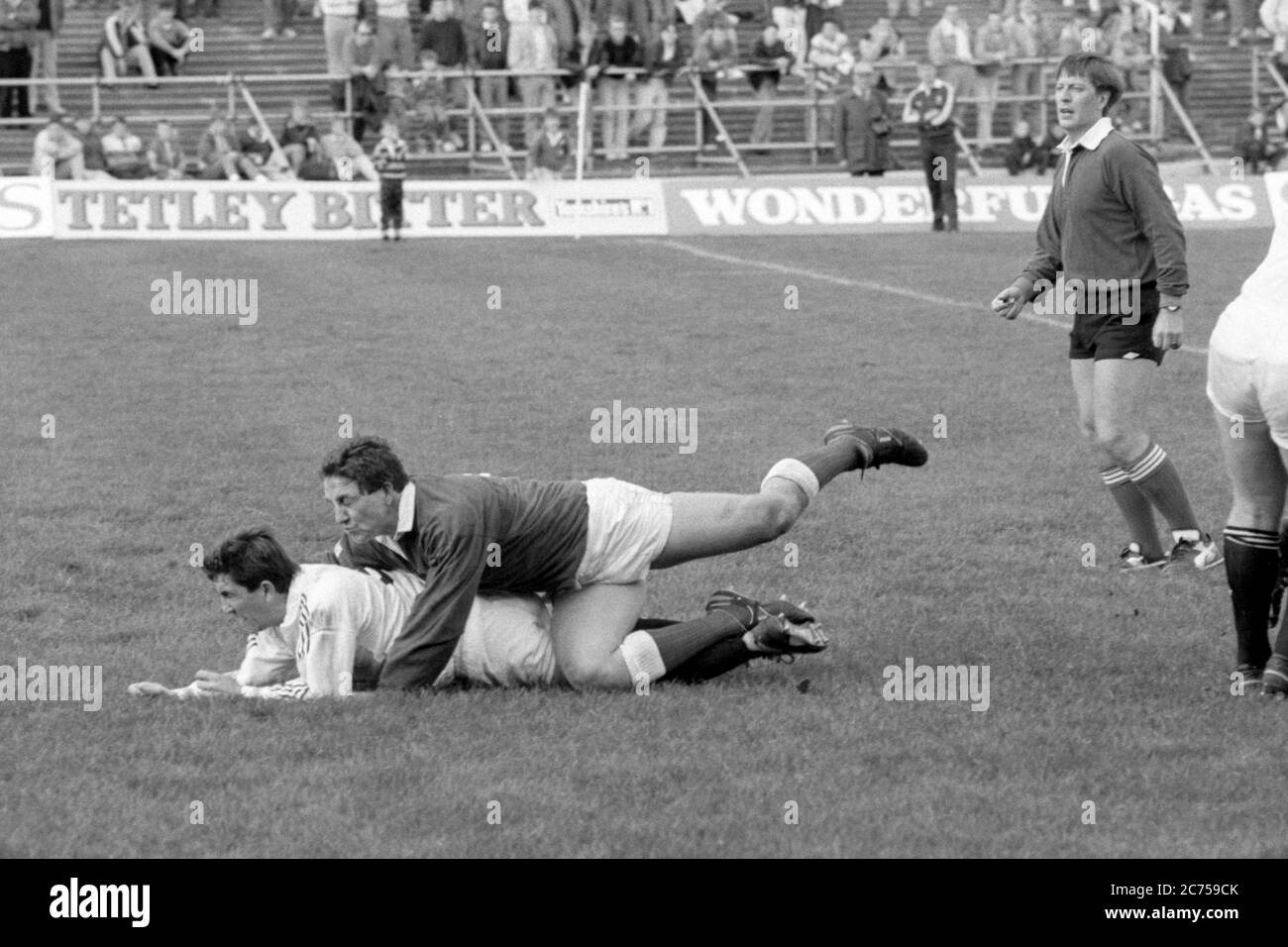 Der Scrum Half Mike Griffiths von Llanelli RFC tagt seinen Gegenspieler Robert Jones vom Swansea RFC während eines Spiels am 14. Oktober 1989 auf dem St. Helen's Rugby and Cricket Ground, Swansea. Stockfoto