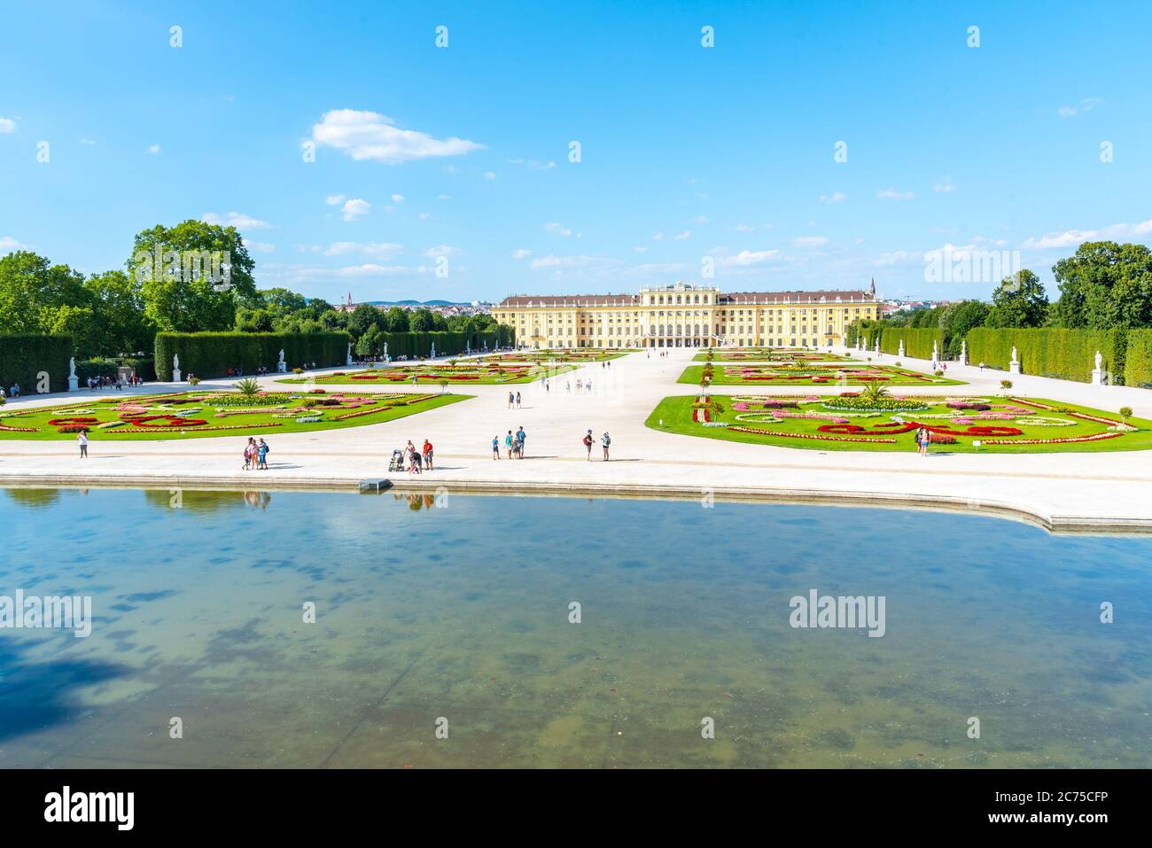 WIEN, ÖSTERREICH - 23. JULI 2019: Schloss Schönbrunn, Deutsch: Schloss Schönbrunn, und großer Parterre - Französischer Garten mit schönen Blumenbeeten, Wien, Österreich Stockfoto