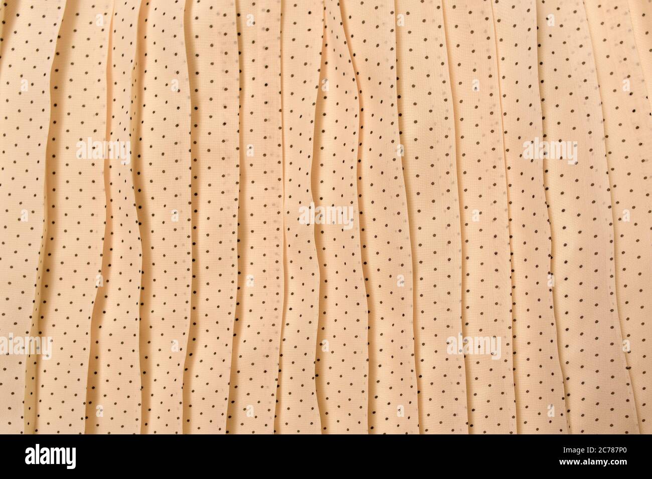 Beige Faltenware in kleinen Erbsen. Texturhintergrund Stockfoto