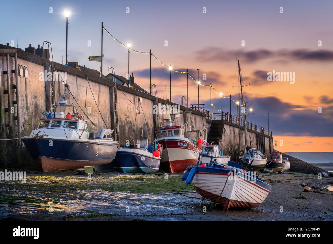 Dämmerung vor Sonnenaufgang auf dem Fluss Torridge, während die kleinen Fischerboote am Kai in Appledore in North Devon auf die ankommende Flut warten, bevor st Stockfoto