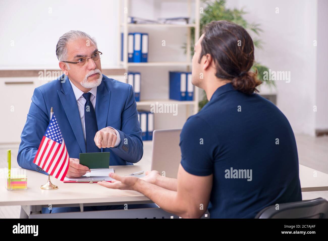 Junger Mann, der die Botschaft für das Visum besucht Stockfoto