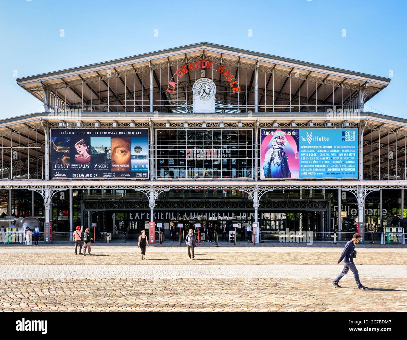 Vorderansicht der Fassade mit Uhr und Zeichen der Grande Halle de la Villette in Paris, einem ehemaligen Schlachthof, der in ein Kulturzentrum umgewandelt wurde. Stockfoto