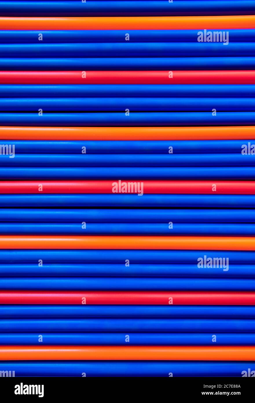 Blau, rot, orange Muster Kunststoff Rohre Strohhalme Hintergrund Stockfoto