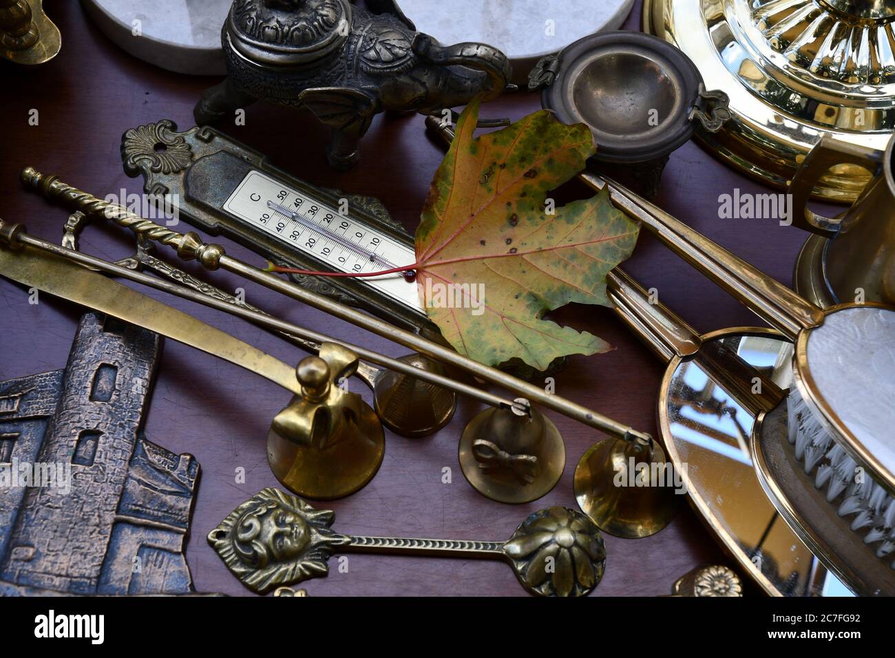 Flache Lage von Vintage verzierten Objekten und Herbst Ahornblatt in der Nähe Retro-Thermometer. Flohmarkt antike Sachen und bunte Herbstblatt Nahaufnahme Stockfoto