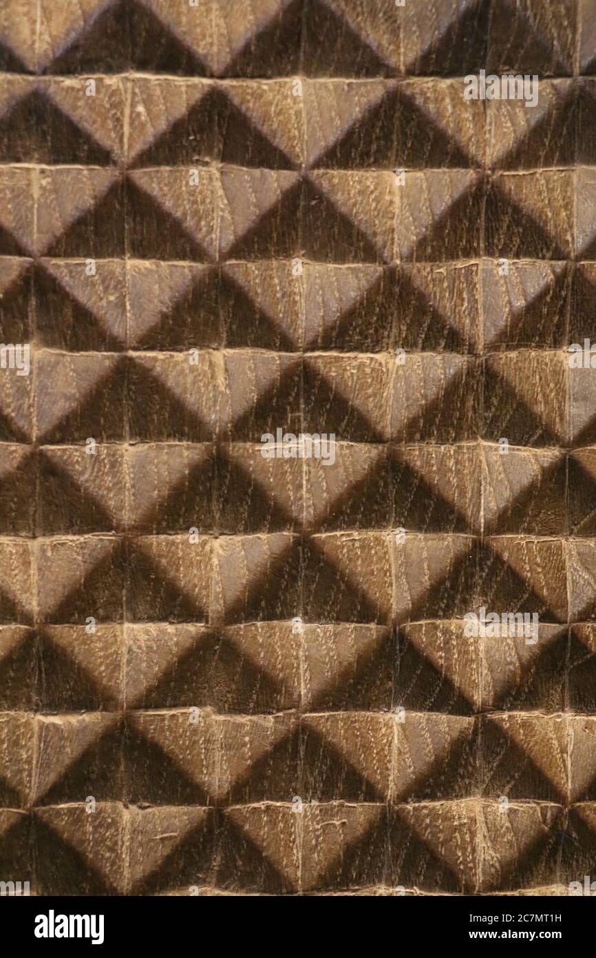 Holzoberfläche, die durch natürliche Maserungen abstrakte Quadrate und Dreiecke offenbart Stockfoto