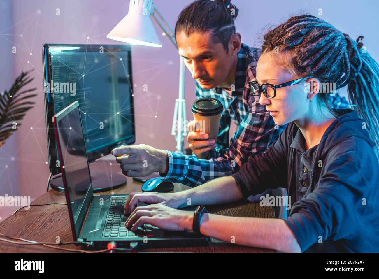 Programmierer entwickeln Software, indem sie mit Software-Code zusammen arbeiten. Teamarbeit. Moderne Arbeit eines IT-Ingenieurs. Stockfoto