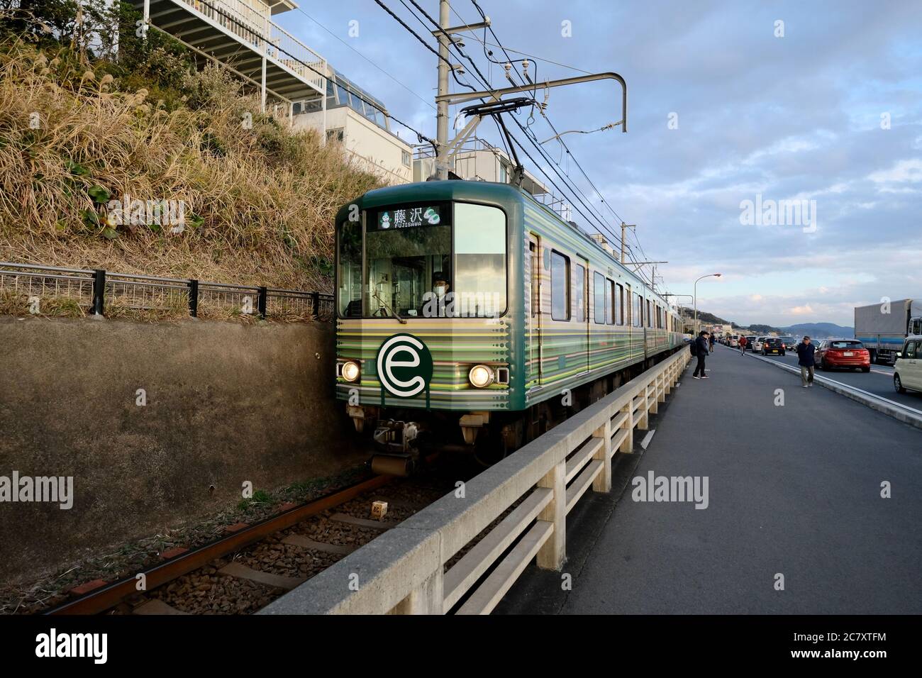 Zug der Enoshima Electric Railway in der Nähe der Kamakurakokomae Station. Perspektive Stockfoto