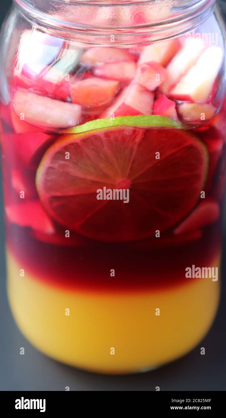 Lebendige Farbe der hausgemachten Rotwein Sangria in einer Grasflasche vor dem Mischen Stockfoto