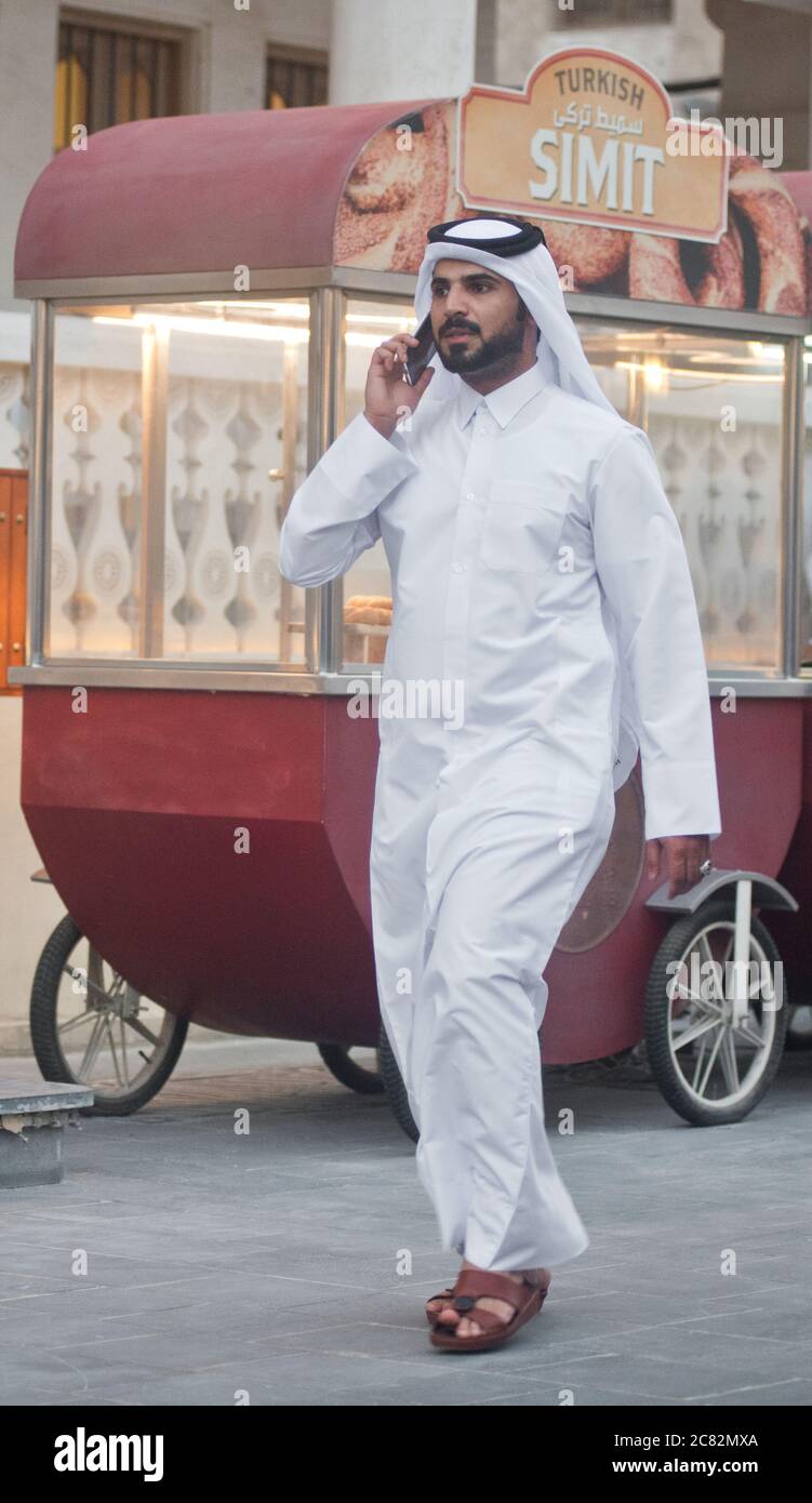 Muslimischer saudi-Mann, der am Handy in Souq Waqif, Doha, Katar, spricht Stockfoto